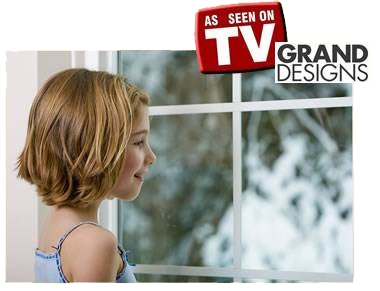 a young girl looking out of a sash window